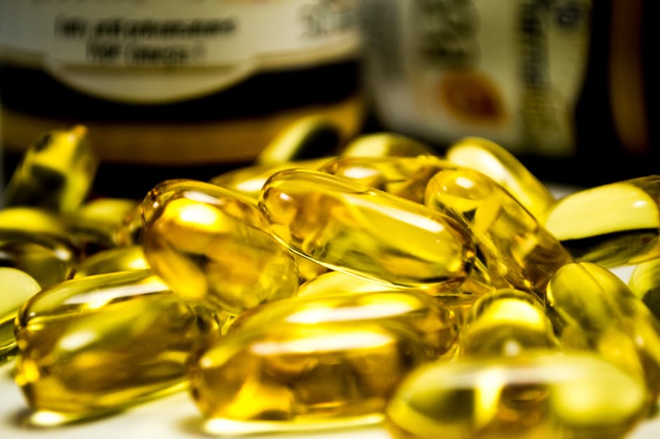 Photo of fish oil and other supplements, and holistic, complementary and alternative medicine in the background